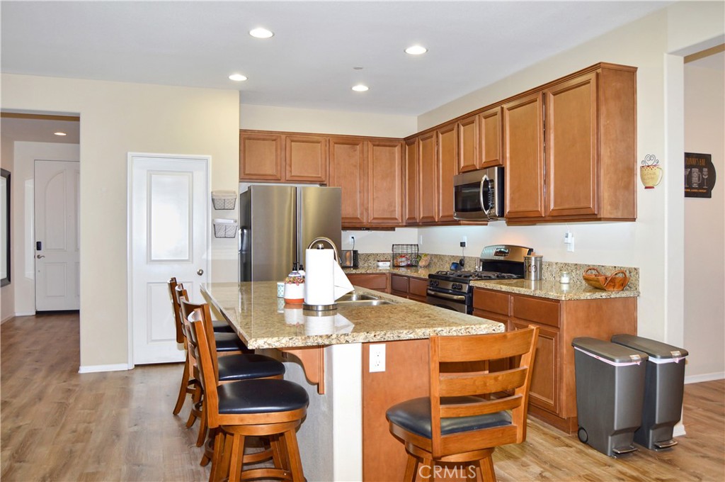 166 Fox Lane Calimesa, CA 92320 - Photo 17 of 76 This Kitchen is a Great Place to Gather with Granite-topped Counters, Island Seating, Stainless Steel Appliances, a Coffee Bar, and a Walk-in Pantry - All Open to the Living Area, Dining Room, and Back Patio