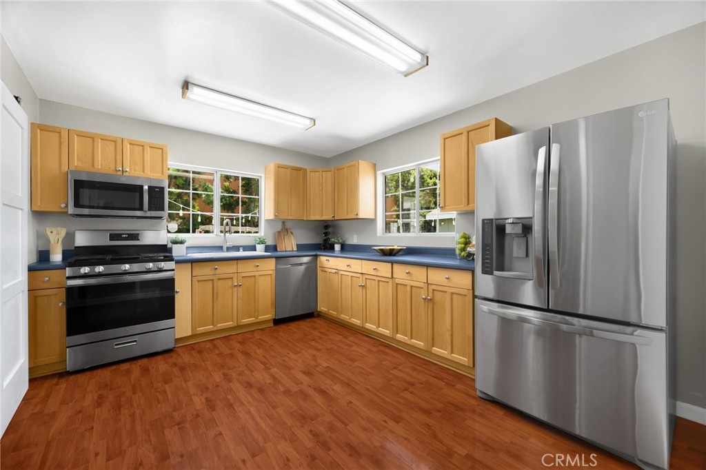 836 Willow Drive Brea, CA 92821 - Photo 12 of 35 a kitchen with granite countertop stainless steel appliances a refrigerator cabinets and a window