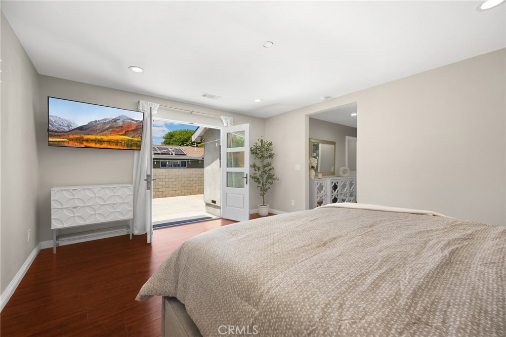 836 Willow Drive Brea, CA 92821 - Photo 15 of 35 a spacious bedroom with a bed and a painting on the wall