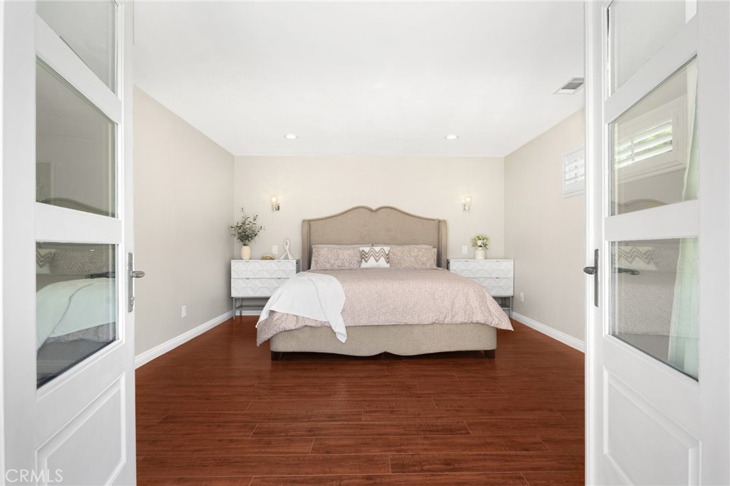 836 Willow Drive Brea, CA 92821 - Photo 17 of 35 a bedroom with a bed and wooden floor