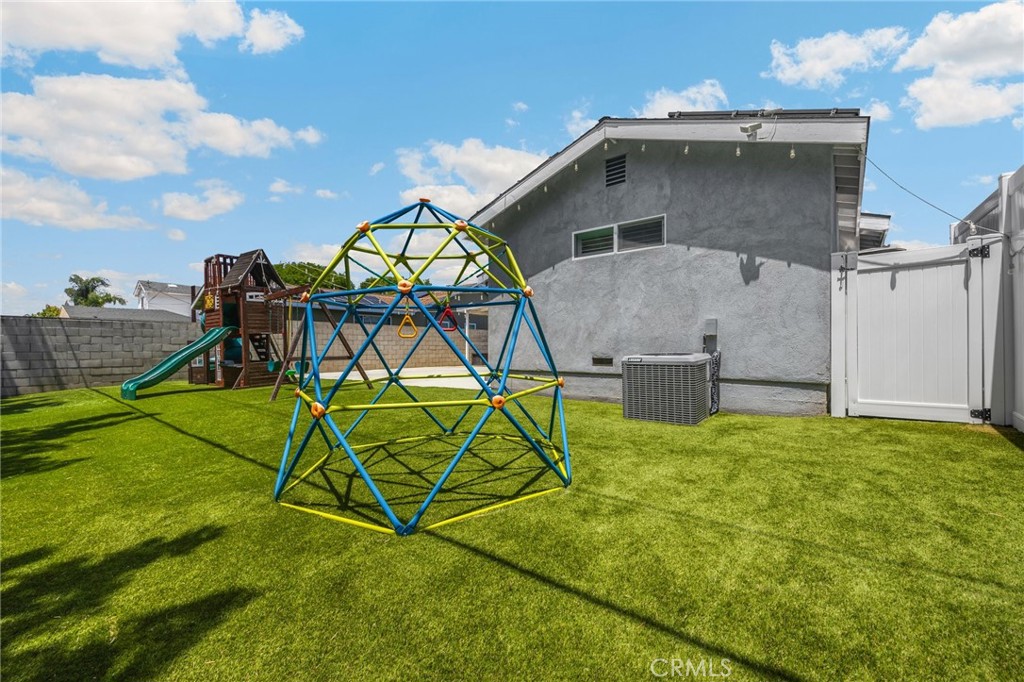 836 Willow Drive Brea, CA 92821 - Photo 35 of 35 a yellow house with a yard and a wooden fence