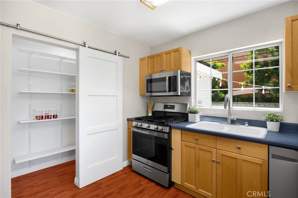 836 Willow Drive Brea, CA 92821 - Photo 10 of 35 a kitchen with kitchen island granite countertop a stove a sink and a microwave