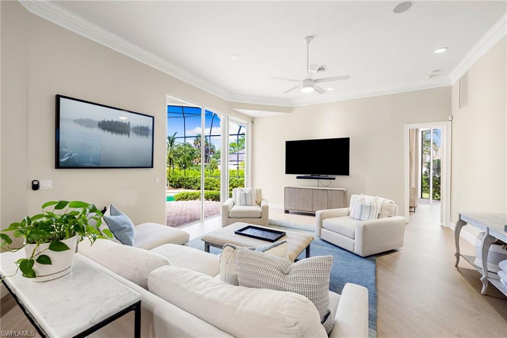 707 Hickory Road Naples, FL 34108 - Photo 26 of 38 a living room with furniture and a flat screen tv