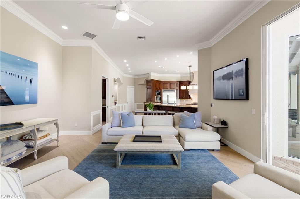 707 Hickory Road Naples, FL 34108 - Photo 31 of 38 a living room with furniture a rug and a flat screen tv