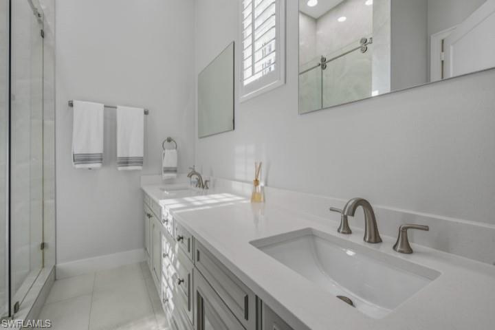 707 Hickory Road Naples, FL 34108 - Photo 33 of 38 a bathroom with a sink and a mirror