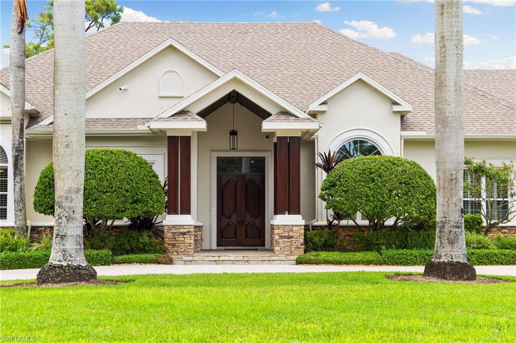 707 Hickory Road Naples, FL 34108 - Photo 8 of 39 a front view of a house with a yard