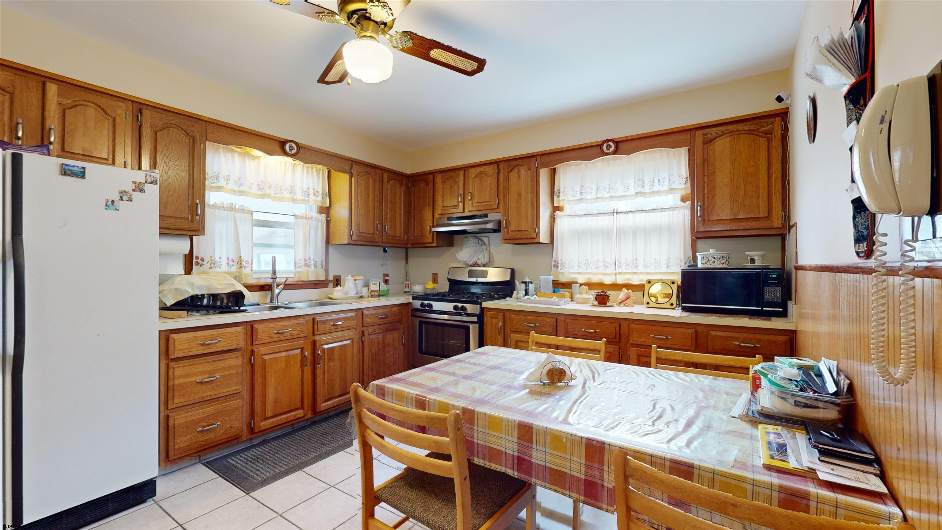 424 Pratt Street Hammonton, NJ 08037 - Photo 11 of 41 a kitchen with stainless steel appliances granite countertop a refrigerator a sink dishwasher a stove and white countertops with wooden floor