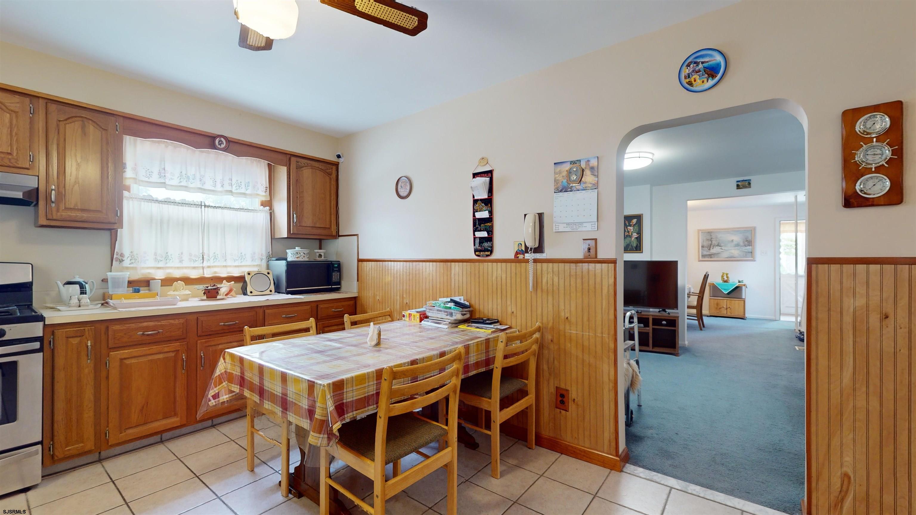 424 Pratt Street Hammonton, NJ 08037 - Photo 14 of 41 a kitchen with a dining table chairs and a refrigerator