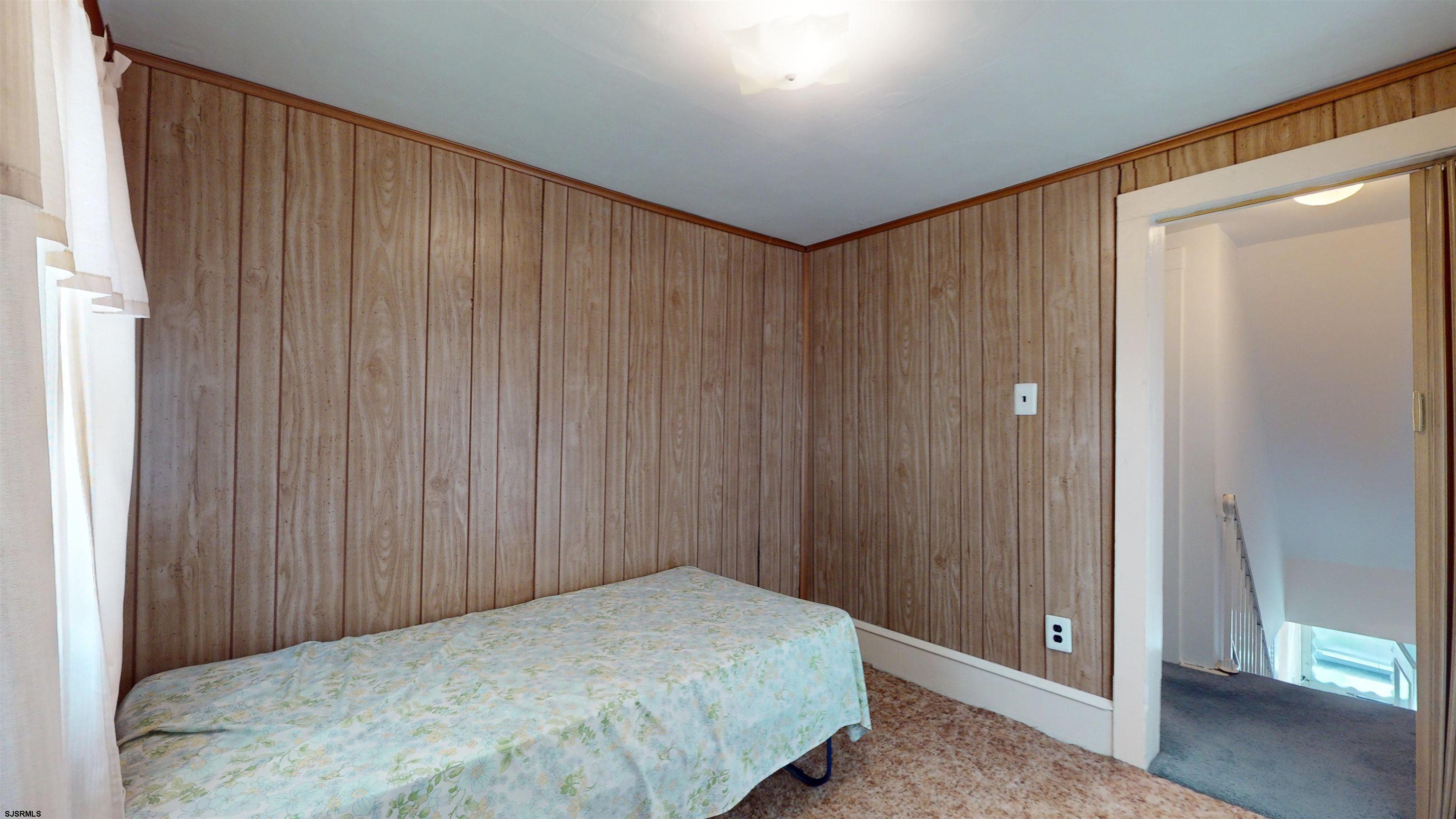 424 Pratt Street Hammonton, NJ 08037 - Photo 26 of 41 a bedroom with a bed and a wooden door