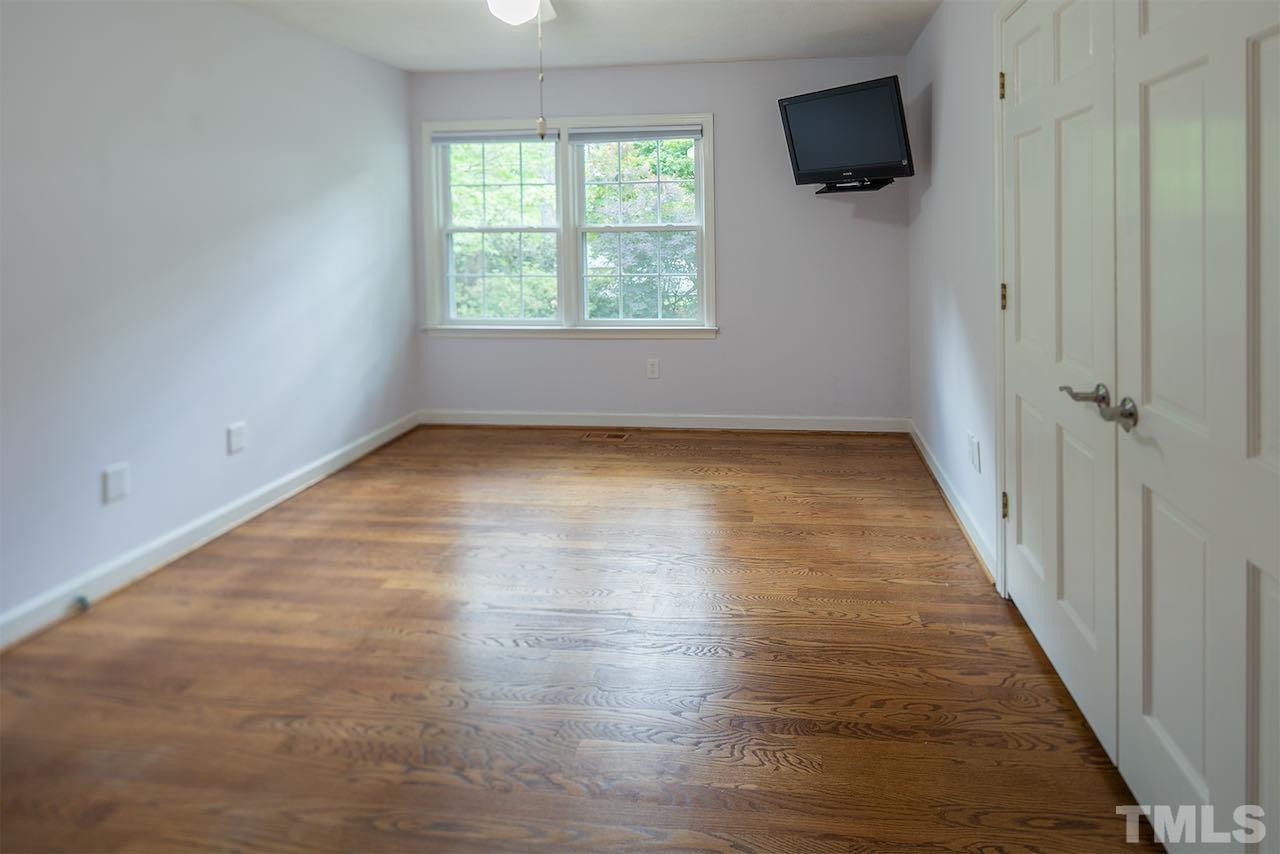6420 Brandywine Road Raleigh, NC 27607 - Photo 17 of 28 an empty room with wooden floor and windows