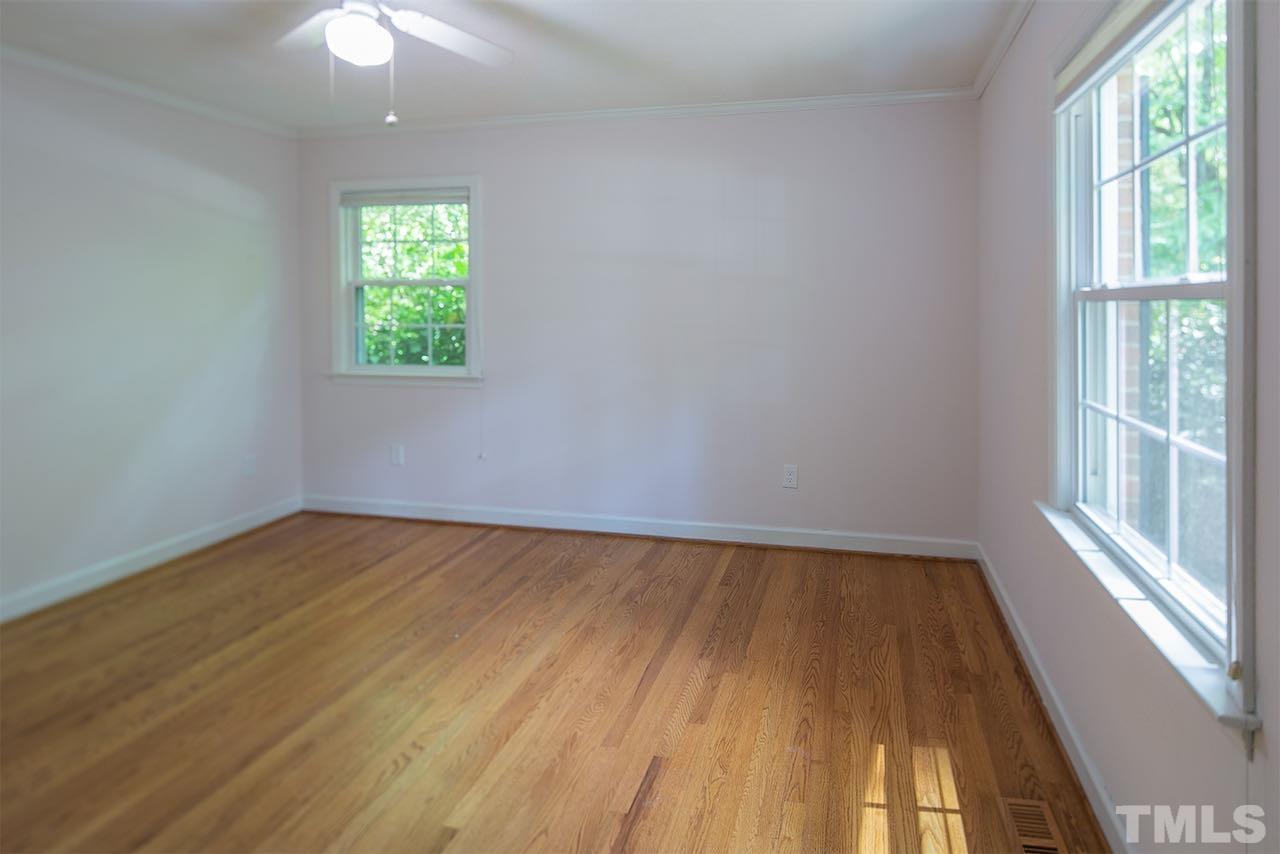 6420 Brandywine Road Raleigh, NC 27607 - Photo 18 of 28 wooden floor in an empty room with a window
