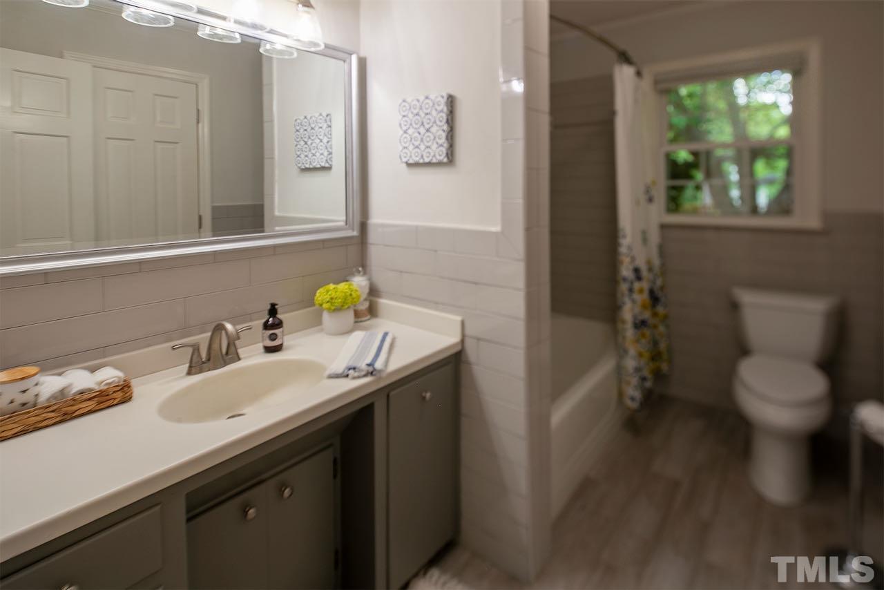 6420 Brandywine Road Raleigh, NC 27607 - Photo 19 of 28 a bathroom with a sink toilet and shower