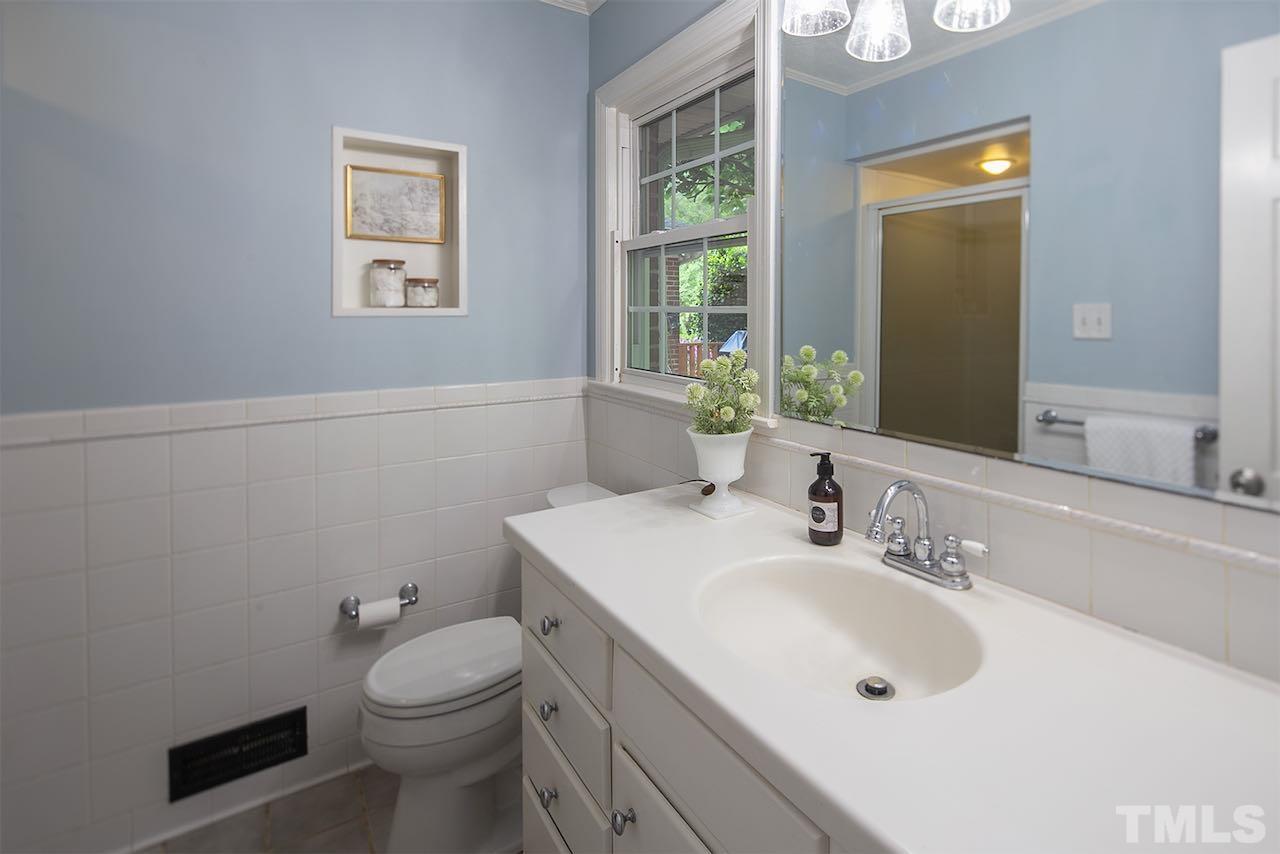 6420 Brandywine Road Raleigh, NC 27607 - Photo 20 of 28 a bathroom with a sink a toilet and mirror