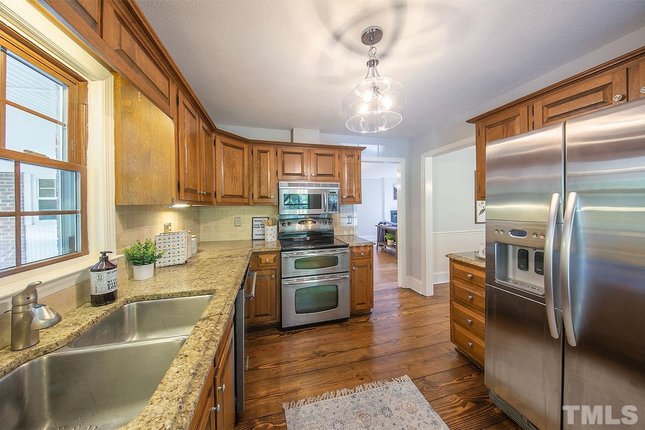 6420 Brandywine Road Raleigh, NC 27607 - Photo 7 of 28 a kitchen with stainless steel appliances granite countertop a refrigerator a sink a stove and cabinets