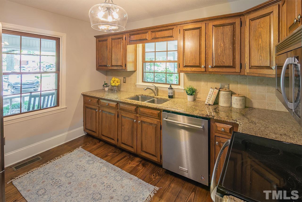 6420 Brandywine Road Raleigh, NC 27607 - Photo 8 of 28 a kitchen with a sink stove and cabinets