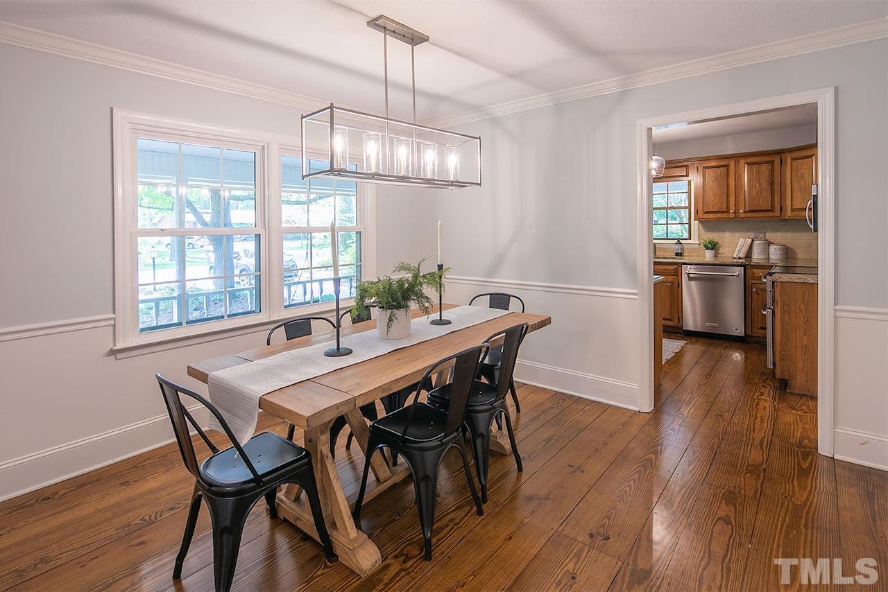 6420 Brandywine Road Raleigh, NC 27607 - Photo 9 of 28 a view of a dining room with furniture wooden floor and chandelier