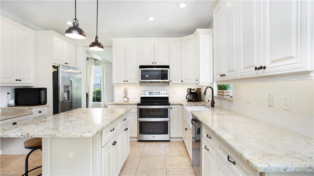 14590 Indigo Lakes Circle Naples, FL 34119 - Photo 8 of 45 Loads of storage space make this kitchen a dream for family meal prep and gathering with friends