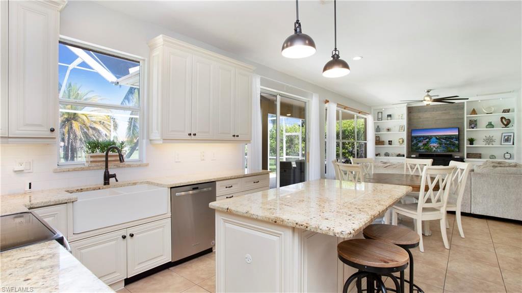 14590 Indigo Lakes Circle Naples, FL 34119 - Photo 9 of 45 Apron sink and granite counters accent this large kitchen with under cabinet lighting