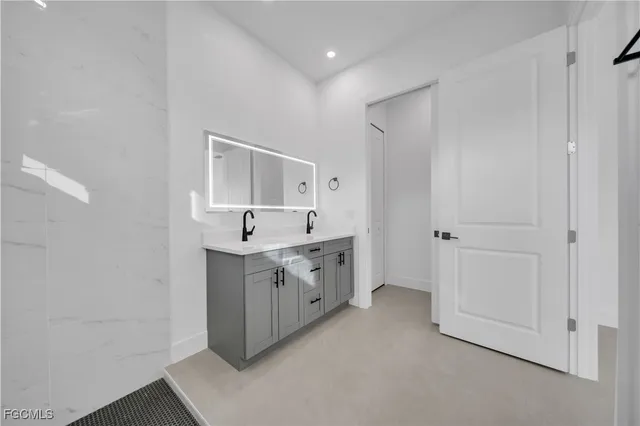 a spacious bathroom with a double vanity sink and a mirror