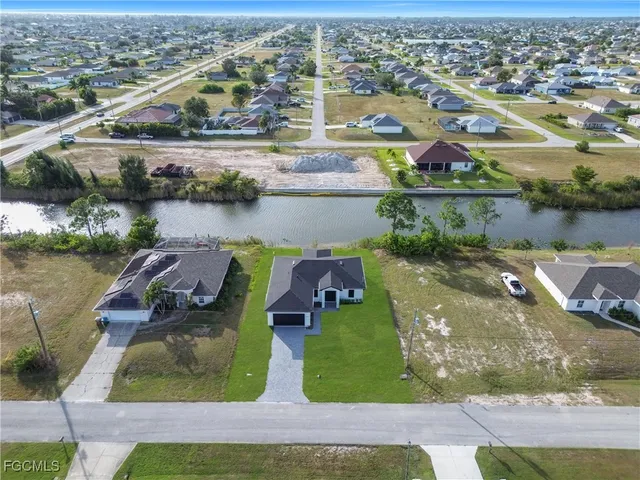 an aerial view of a house with a lake view