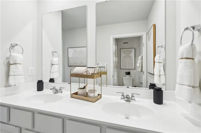 a bathroom with double vanity sinks and a mirror