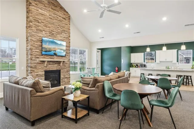 a living room with furniture a fireplace and a flat screen tv