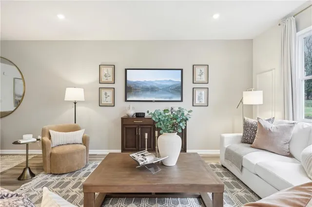 a living room with furniture a window and a table