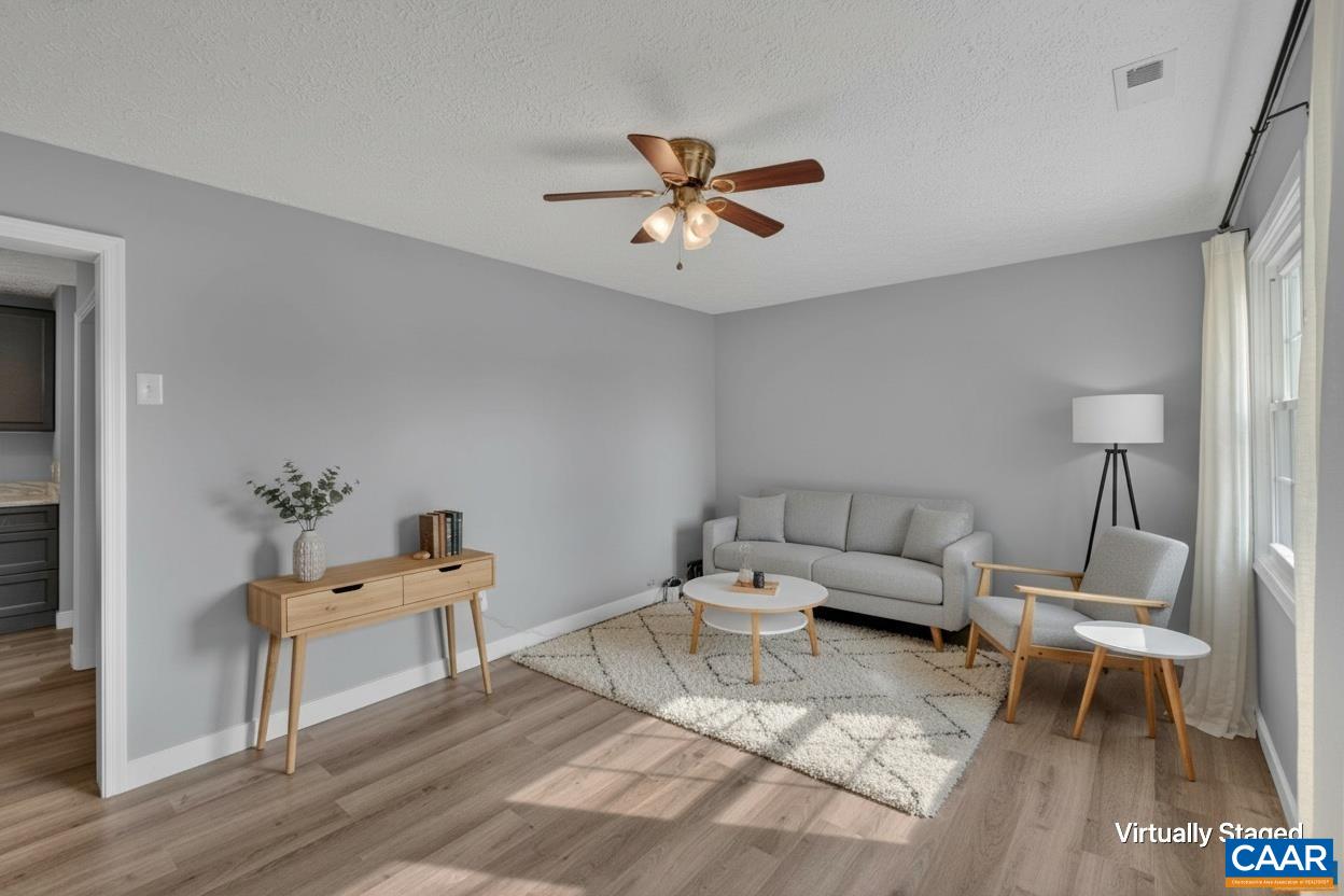 673 Cedar Lane Road Palmyra, VA 22963 - Photo 9 of 47 a living room with furniture and a wooden floor