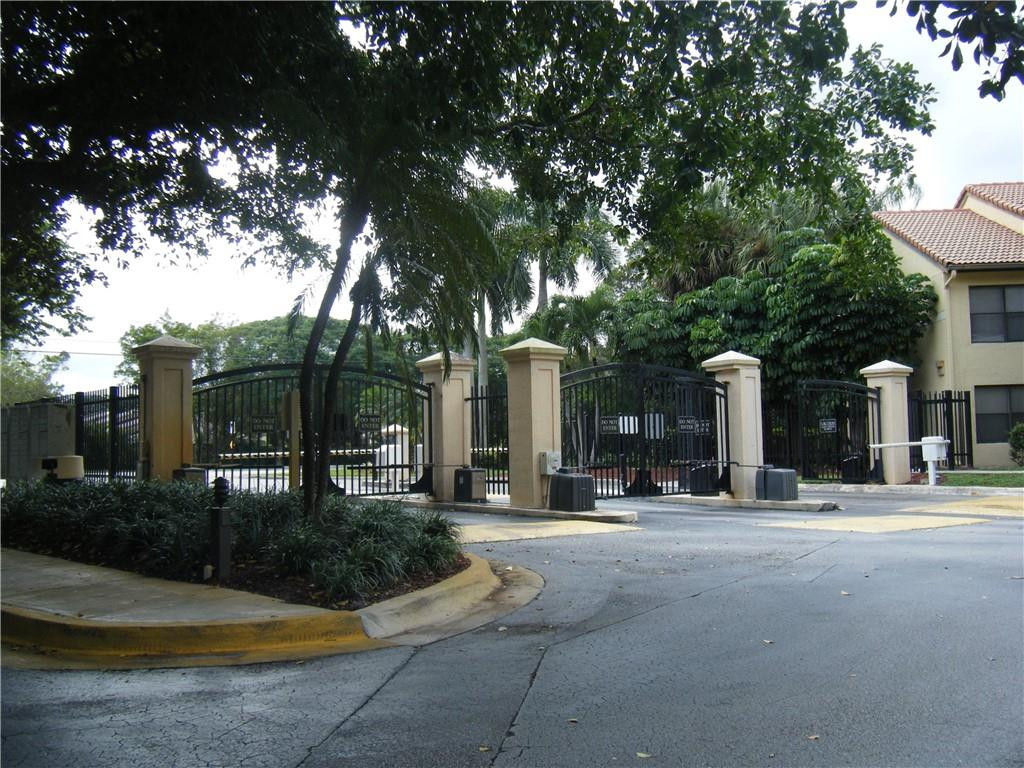 4421 West McNab Road, Unit 19 Pompano Beach, FL 33069 - Photo 18 of 20 a view of a building with a tree in front of it