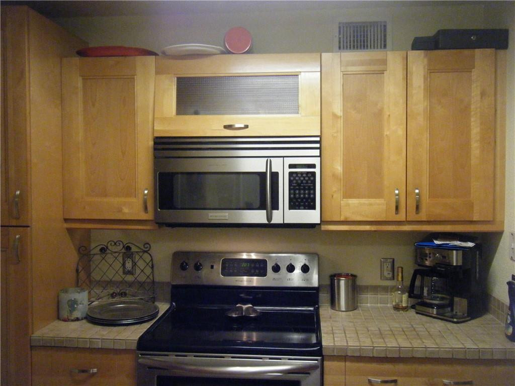 4421 West McNab Road, Unit 19 Pompano Beach, FL 33069 - Photo 4 of 20 a kitchen with granite countertop white cabinets and stainless steel appliances