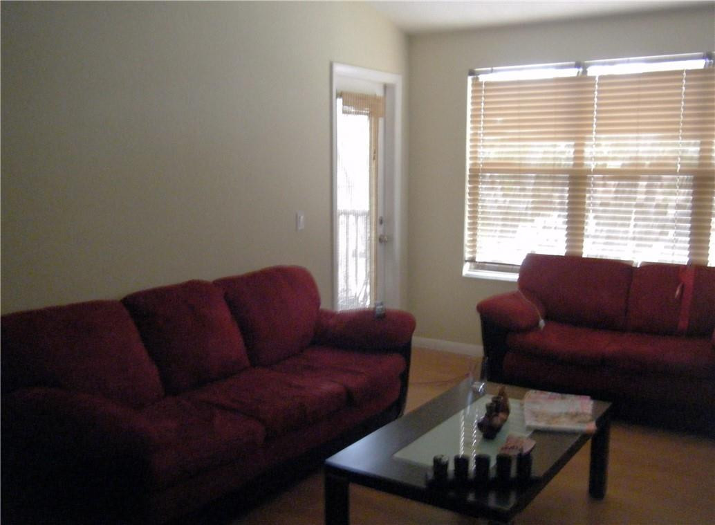 4421 West McNab Road, Unit 19 Pompano Beach, FL 33069 - Photo 5 of 20 a living room with furniture and a large window