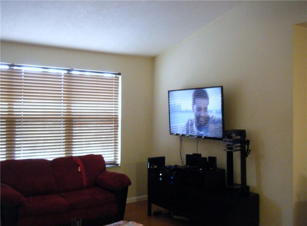 4421 West McNab Road, Unit 19 Pompano Beach, FL 33069 - Photo 6 of 20 a living room with furniture and a window