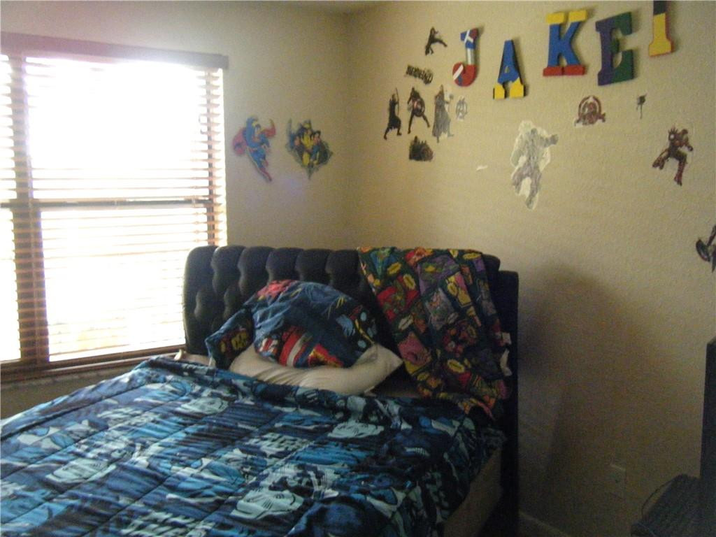 4421 West McNab Road, Unit 19 Pompano Beach, FL 33069 - Photo 10 of 20 a bed sitting in a bedroom next to a window