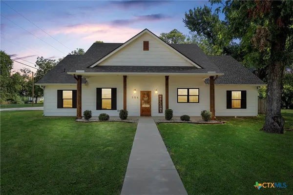 a front view of a house with a yard
