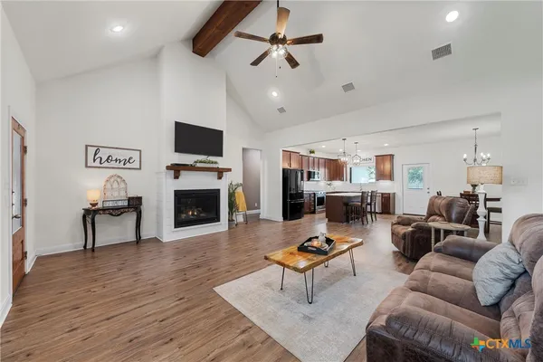 a living room with furniture a fireplace and a flat screen tv