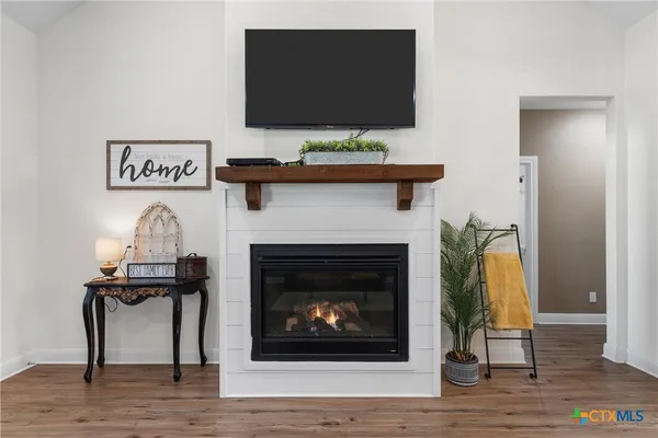 a living room with a fireplace and a flat screen tv