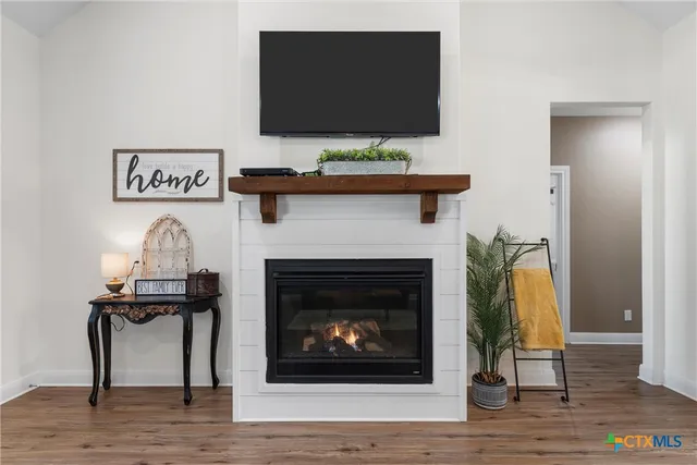 a living room with a fireplace and a flat screen tv
