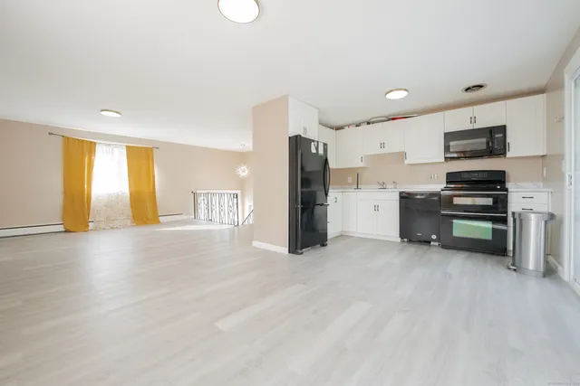 a view of a kitchen with a sink cabinets and entryway