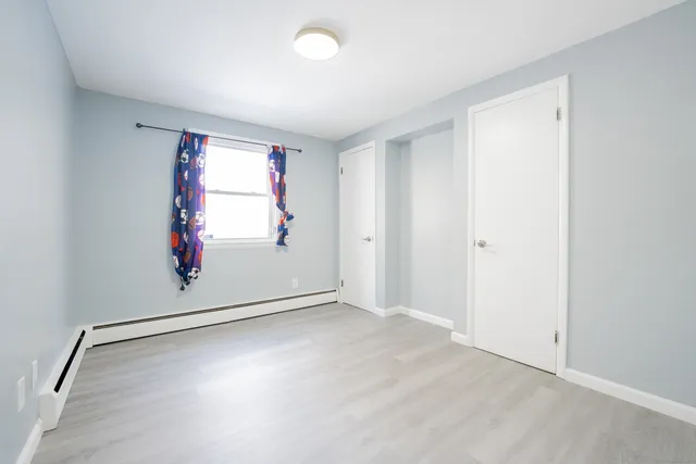 an empty room with windows & door