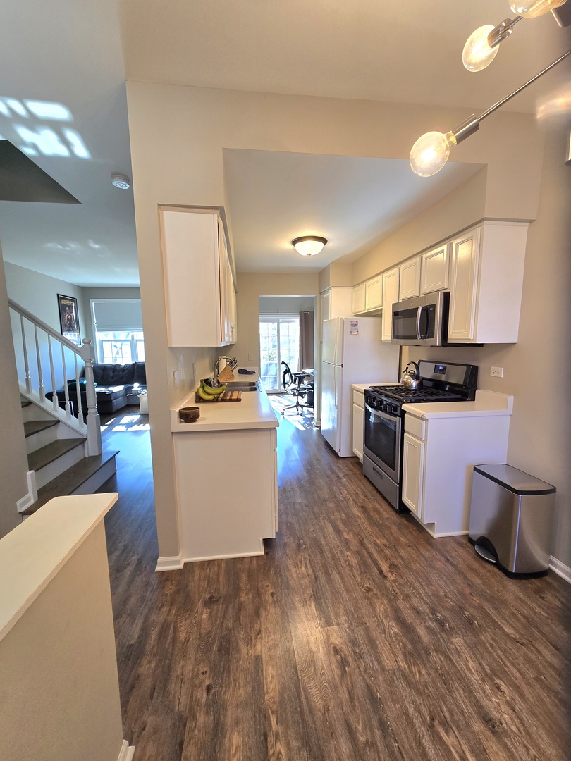 273 West 20th Street Lombard, IL 60148 - Photo 6 of 32 a kitchen with a sink wooden floor and stainless steel appliances