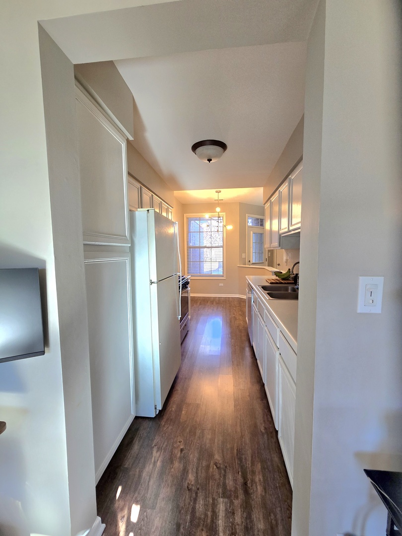 273 West 20th Street Lombard, IL 60148 - Photo 8 of 32 a kitchen with stainless steel appliances a refrigerator and a wooden floor
