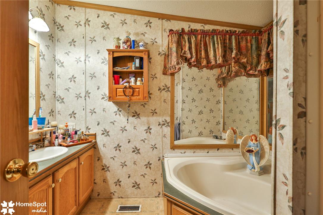 3795 Rhoades Road Kempton, PA 19529 - Photo 12 of 42 A corner soaking tub and vanity provide a cozy bathroom retreat.