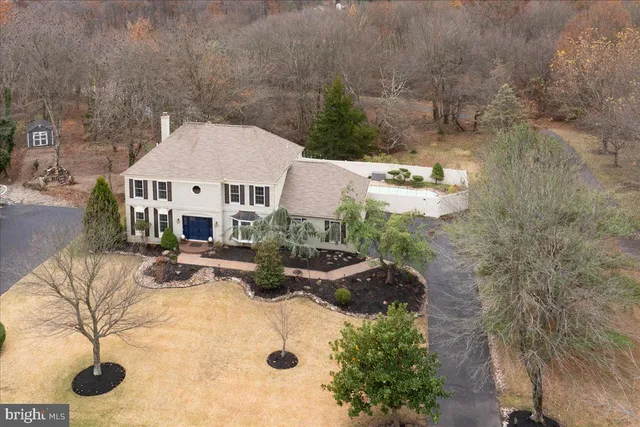 an aerial view of a house with yard and lake view