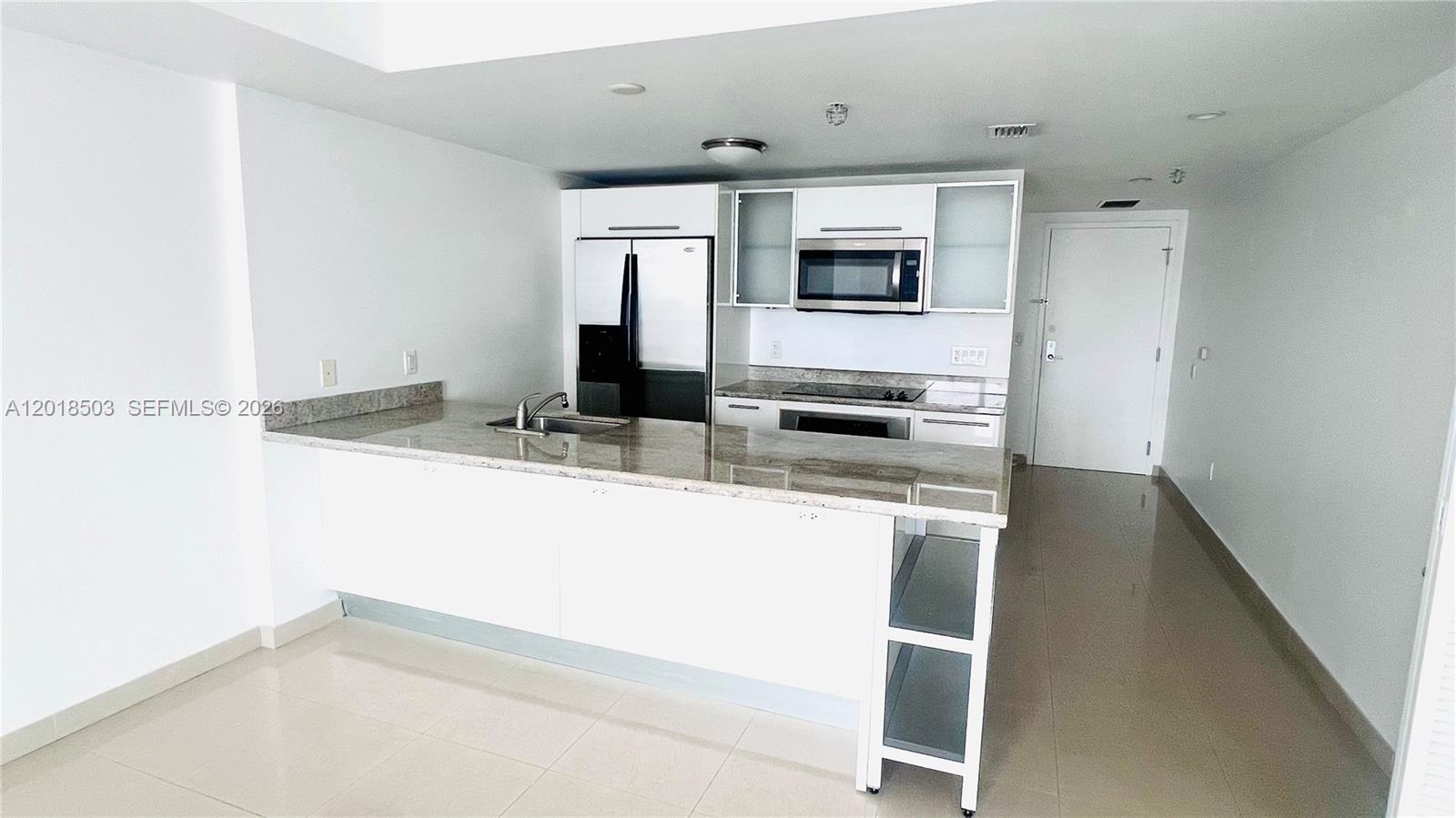 185 Southwest 7th Street, Unit 2805 Miami, FL 33130 - Photo 3 of 6 a kitchen with stainless steel appliances granite countertop a refrigerator and a sink