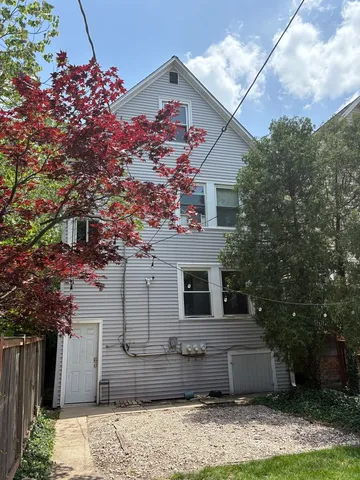 a front view of a house with trees