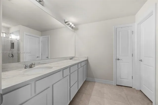 a bathroom with a double vanity sink and a mirror