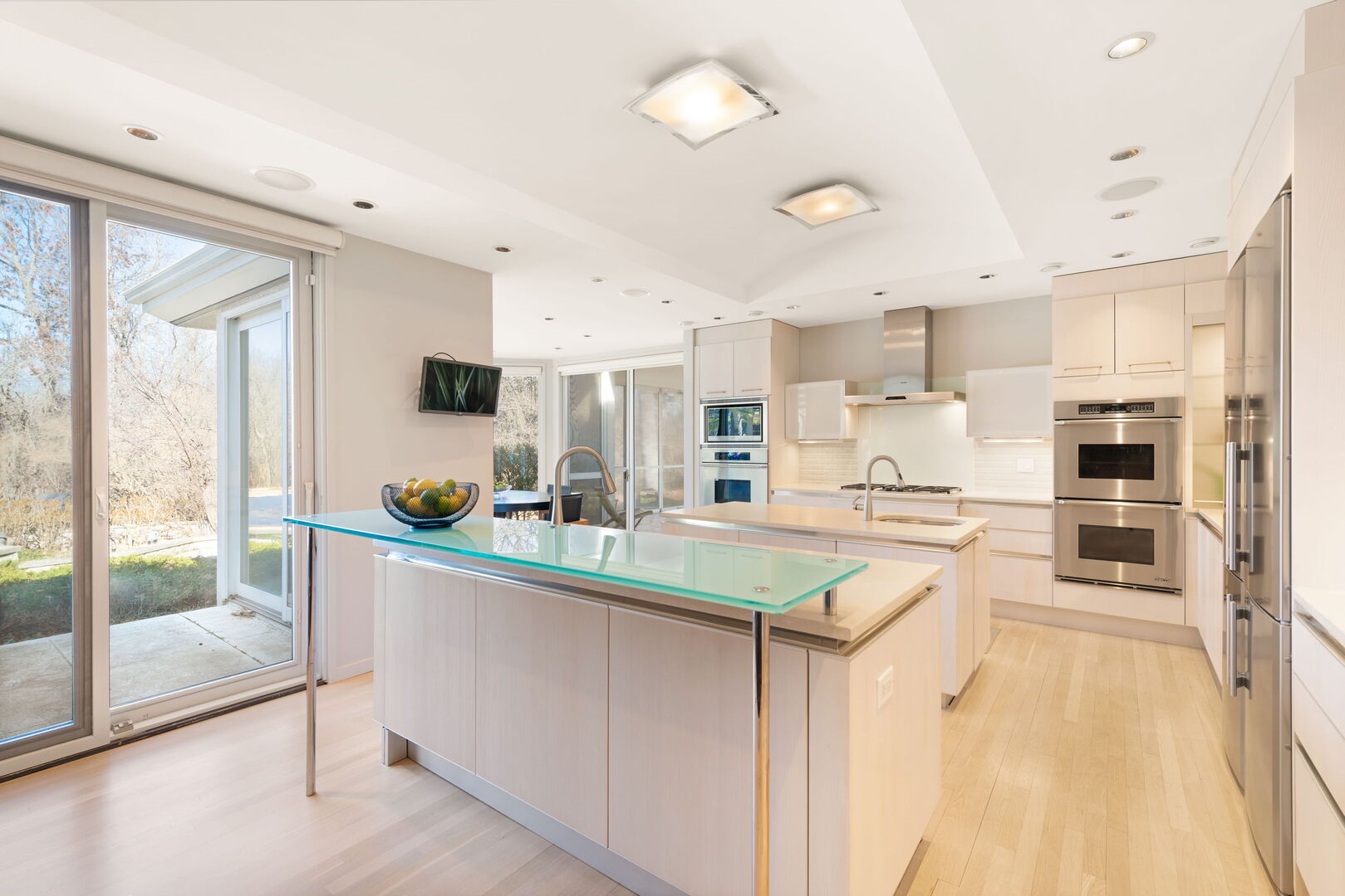 2705 Bentley Road Highland Park, IL 60035 - Photo 15 of 49 a kitchen with stainless steel appliances a refrigerator a stove a sink dishwasher a oven with white cabinets and wooden floor