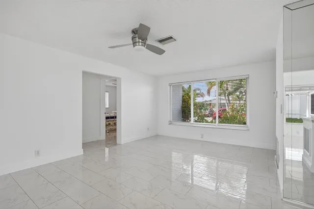 a view of a kitchen with furniture and an empty room