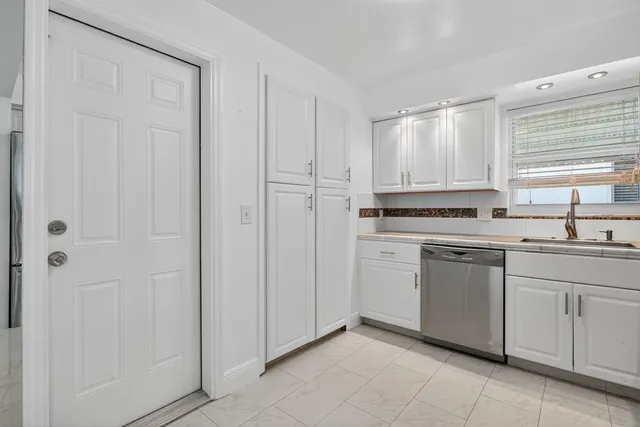 a bathroom with a shower and a glass door