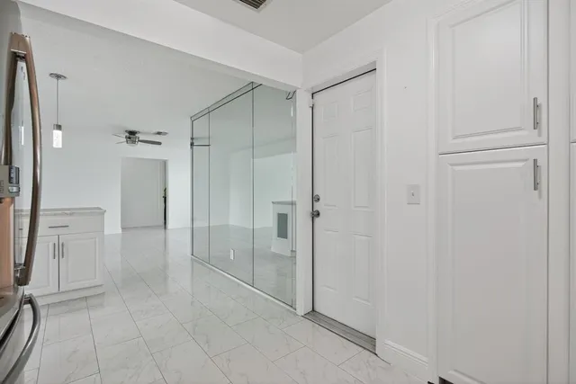 a kitchen with stainless steel appliances white cabinets and a stove top oven